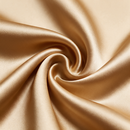 Macro close-up of camel-gold copper-infused satin showing its weave and sheen